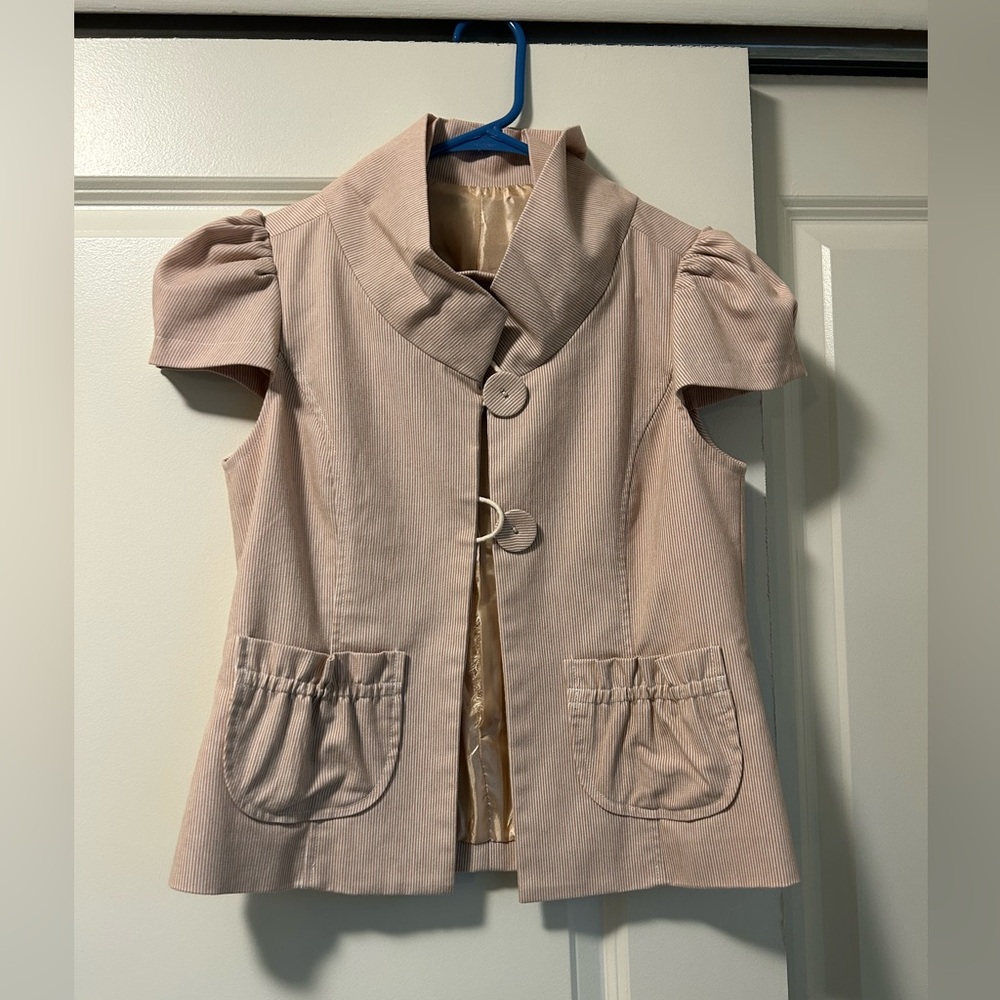 Vintage women’s tailored top with ruffle details.